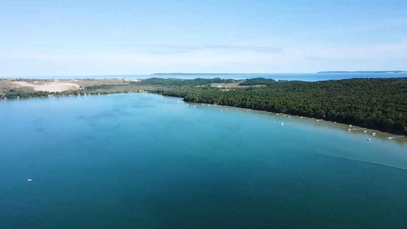 A Clear View of Glen Lake, Surrounded by Lush Greenery and Dotted with Boats on The Water